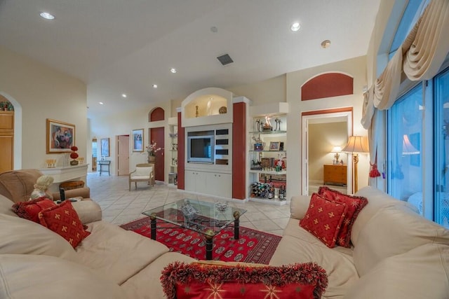 tiled living room with a high ceiling