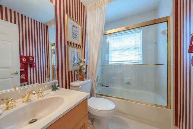 full bathroom with tile patterned floors, vanity, combined bath / shower with glass door, and toilet