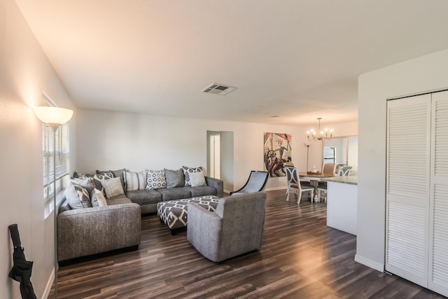 living room with dark hardwood / wood-style flooring and a chandelier