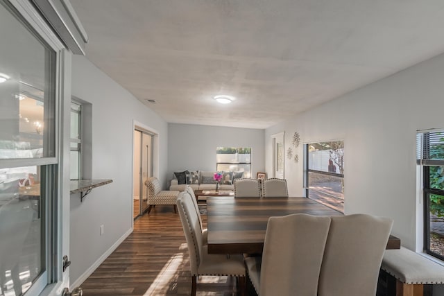 dining space with dark wood-type flooring