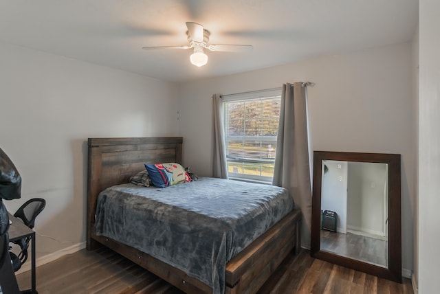 bedroom with ceiling fan and dark hardwood / wood-style flooring