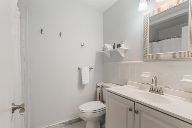 bathroom with tile patterned flooring, vanity, and toilet