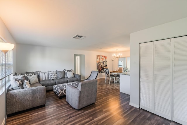 living room with a notable chandelier, a healthy amount of sunlight, and dark hardwood / wood-style flooring