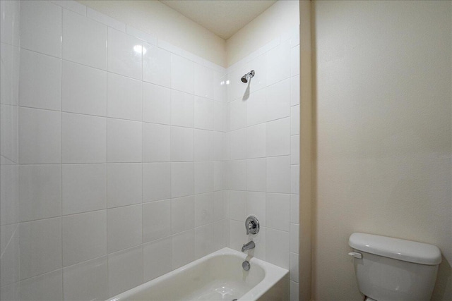 bathroom featuring tiled shower / bath and toilet