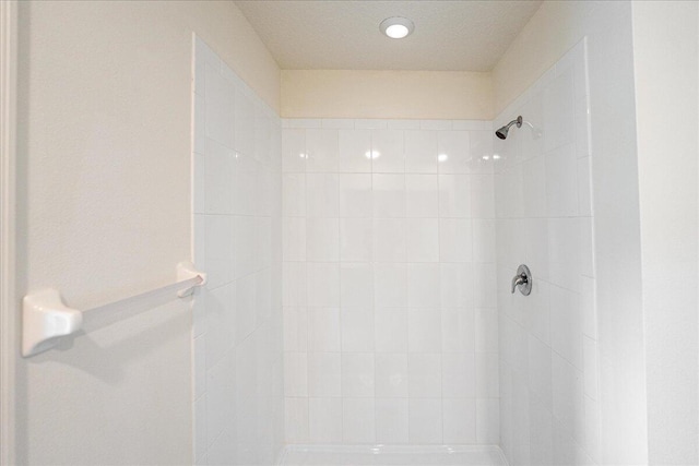 bathroom with tiled shower