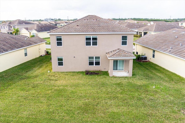 back of house with a lawn