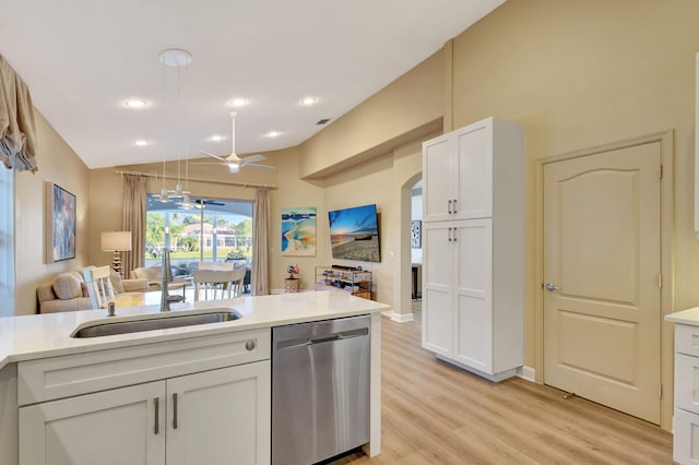 kitchen with white cabinetry, sink, hanging light fixtures, light wood-type flooring, and stainless steel dishwasher