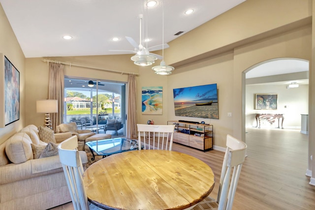 dining area with lofted ceiling, ceiling fan, and light hardwood / wood-style floors