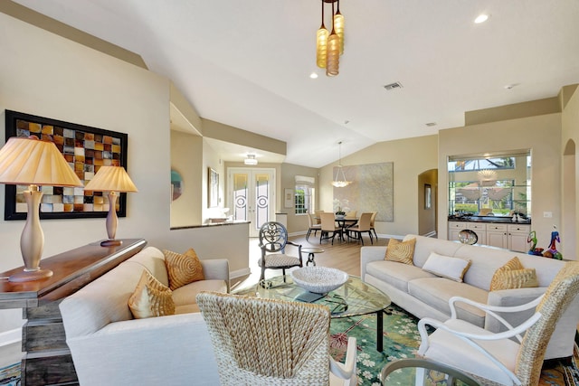 living room with vaulted ceiling and hardwood / wood-style flooring