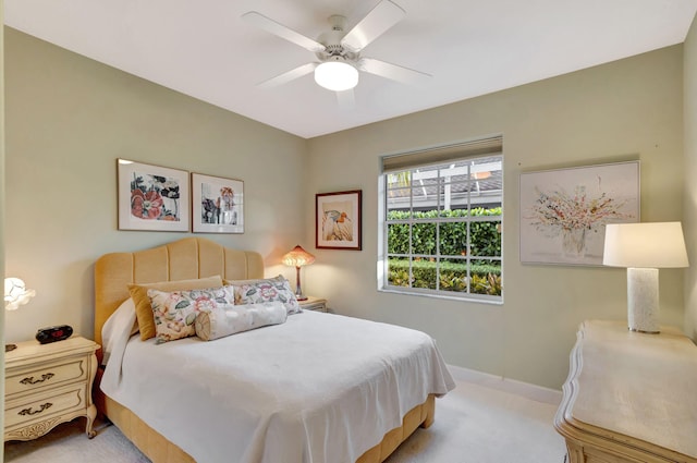 bedroom with ceiling fan and light colored carpet