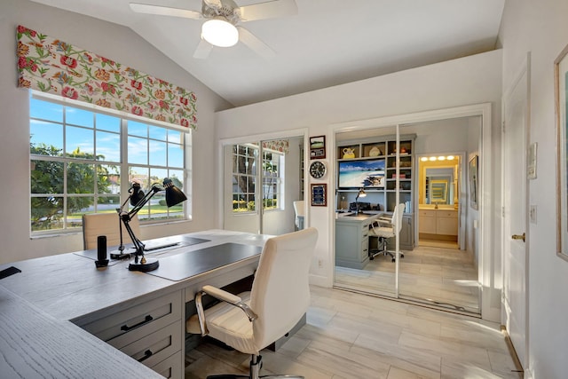 office space with ceiling fan, a healthy amount of sunlight, and vaulted ceiling