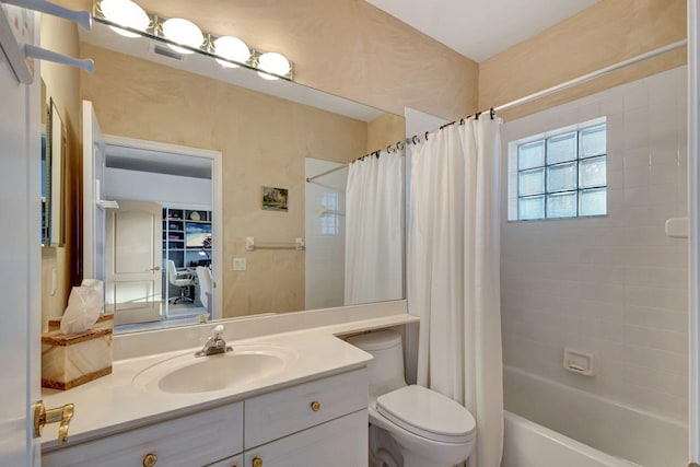 full bathroom with toilet, vanity, and shower / tub combo