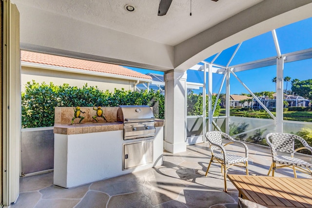 view of patio / terrace featuring grilling area, an outdoor kitchen, and a lanai