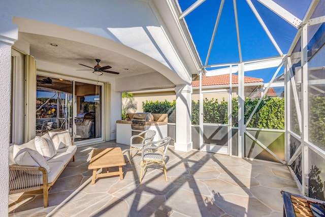 view of patio / terrace with grilling area, ceiling fan, and an outdoor kitchen