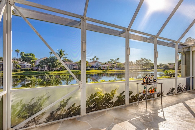 unfurnished sunroom with a water view