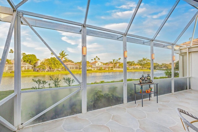 unfurnished sunroom with a water view