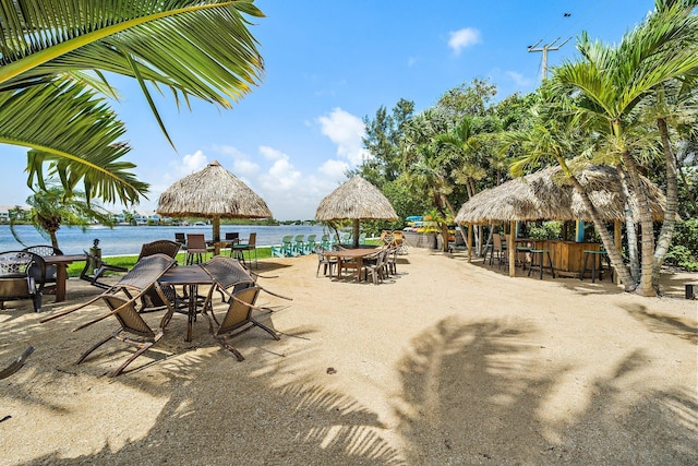 exterior space with a water view and a bar