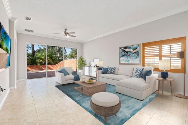 living room featuring ceiling fan, a wealth of natural light, light tile patterned floors, and ornamental molding