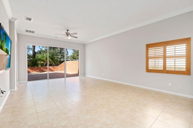 tiled empty room with ceiling fan, ornamental molding, and a textured ceiling