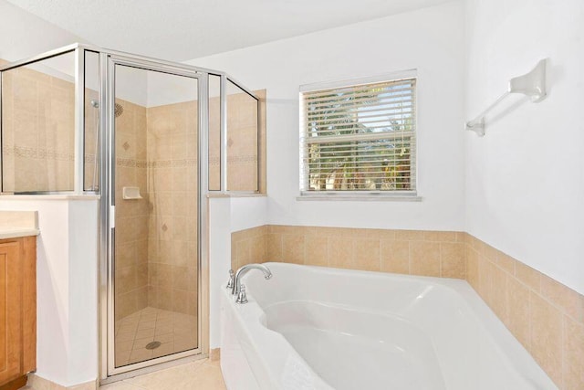 bathroom with shower with separate bathtub, vanity, and tile patterned floors