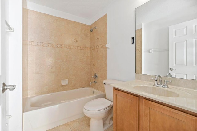 full bathroom featuring tile patterned floors, vanity, toilet, and tiled shower / bath