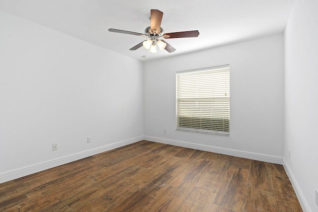 empty room with dark hardwood / wood-style flooring