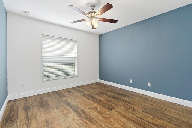 empty room featuring ceiling fan and dark hardwood / wood-style flooring