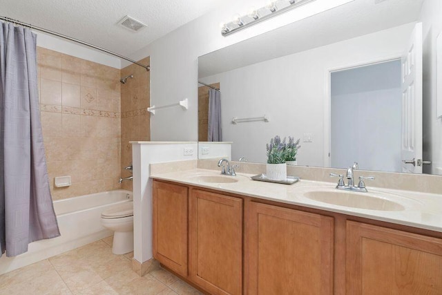 full bathroom with shower / bath combo, vanity, tile patterned flooring, toilet, and a textured ceiling