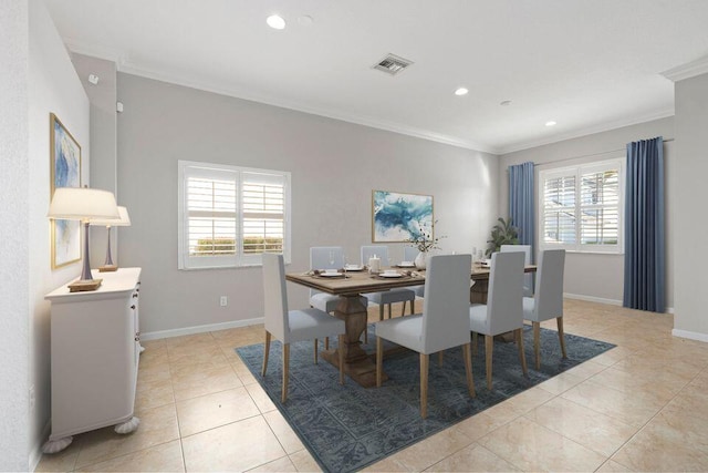 dining room with ornamental molding and light tile patterned floors