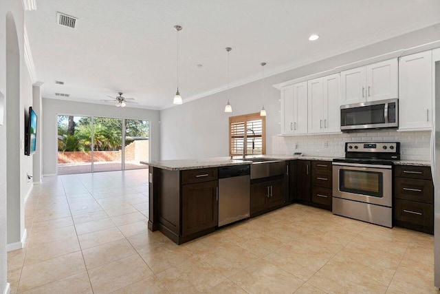 kitchen with ceiling fan, a healthy amount of sunlight, white cabinetry, and appliances with stainless steel finishes