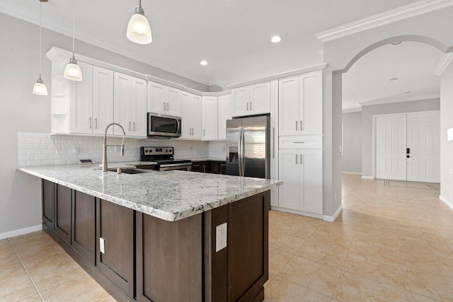 kitchen with white cabinets, sink, hanging light fixtures, and appliances with stainless steel finishes