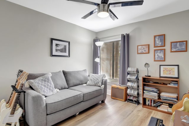 living room with ceiling fan and light hardwood / wood-style flooring