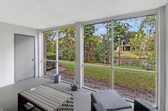 sunroom / solarium featuring a water view