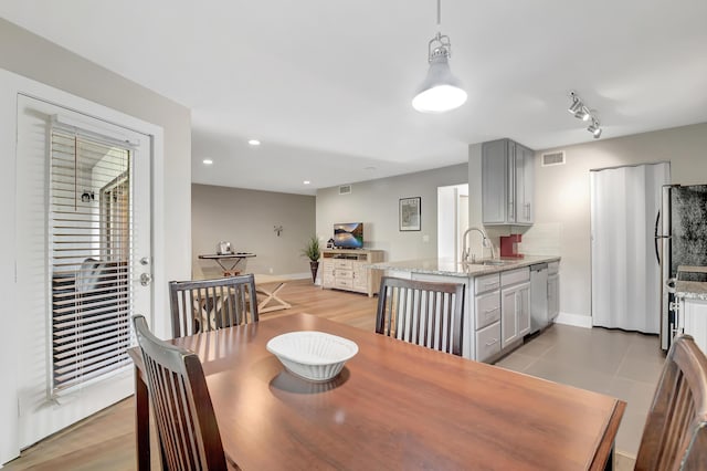 dining room featuring light wood-type flooring and sink