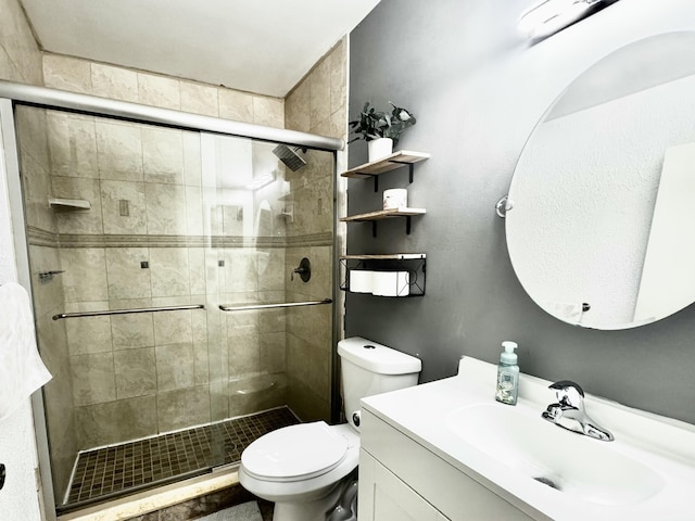 bathroom featuring vanity, toilet, and walk in shower