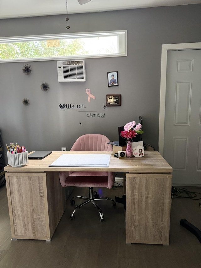 home office with dark hardwood / wood-style flooring and an AC wall unit