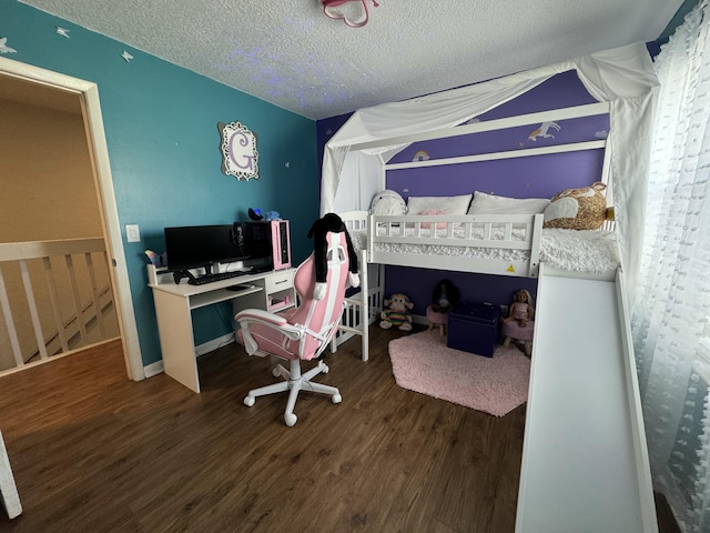 bedroom featuring dark hardwood / wood-style flooring, a textured ceiling, and vaulted ceiling