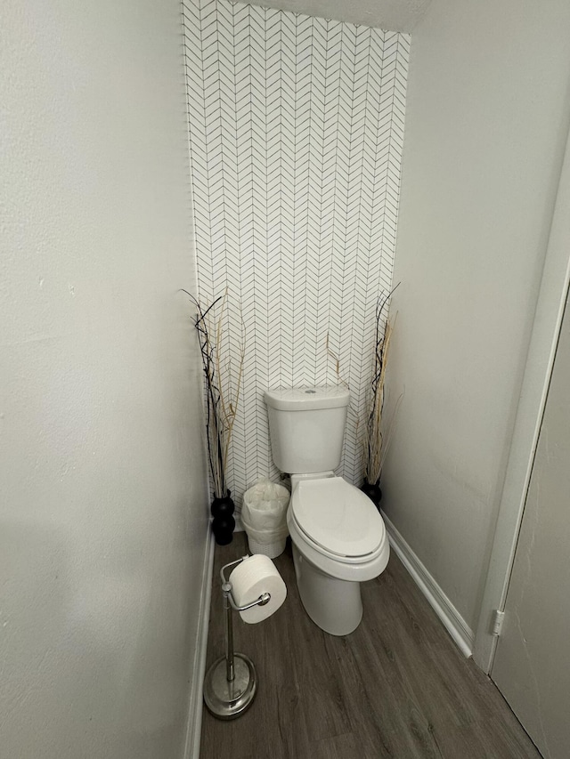 bathroom featuring toilet and hardwood / wood-style flooring