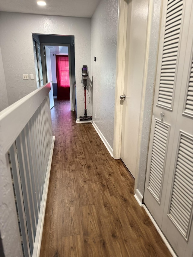 hallway featuring dark hardwood / wood-style flooring