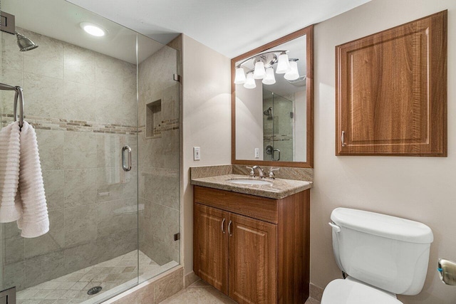 bathroom with toilet, a shower with shower door, and vanity