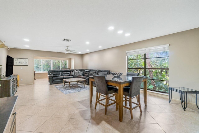 dining space with ceiling fan and light tile patterned floors