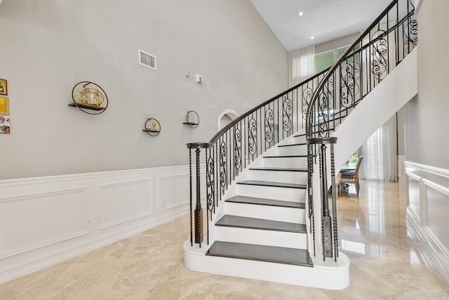 stairs featuring a high ceiling