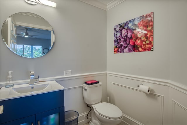 bathroom featuring ceiling fan, toilet, ornamental molding, and vanity