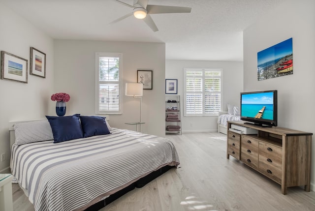 bedroom featuring light hardwood / wood-style floors and ceiling fan