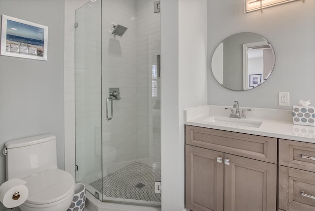 bathroom with walk in shower, vanity, and toilet