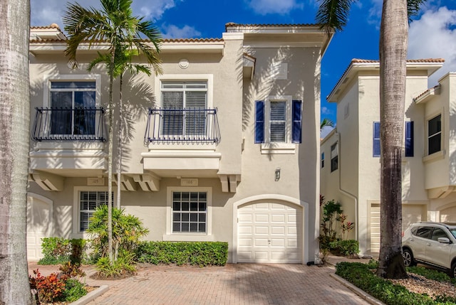 view of front of home featuring a balcony and a garage