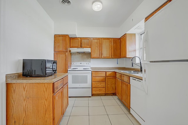 kitchen featuring white appliances, light tile patterned floors, visible vents, under cabinet range hood, and a sink