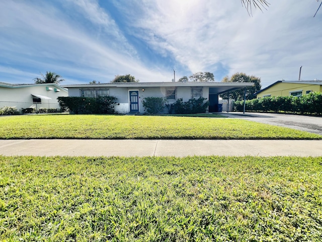 single story home with a front yard and a carport