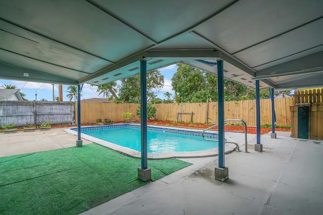 view of swimming pool with a patio, a yard, a fenced backyard, and a fenced in pool