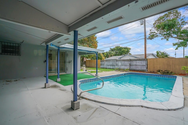 view of swimming pool featuring a fenced in pool, a fenced backyard, and a patio